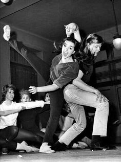 black and white photograph of group of people dancing