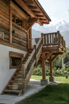 a wooden house with stairs leading up to it