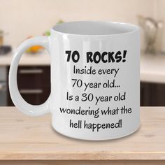 a white coffee mug with the words 70 rocks inside every 70 year old is a 30 year old wondering what the hell happened