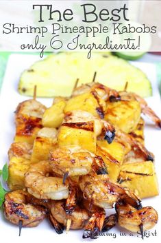 shrimp and pineapple kabobs on a white plate