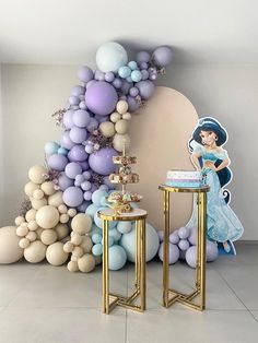 a room with balloons, tables and decorations on the walls in pastel colors for a princess themed birthday party