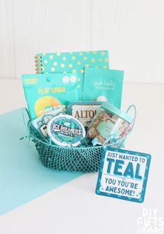 a teal gift basket filled with lots of goodies