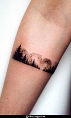 a forest tattoo on the arm