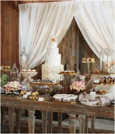 a table topped with lots of different types of cakes and cupcakes on top of it