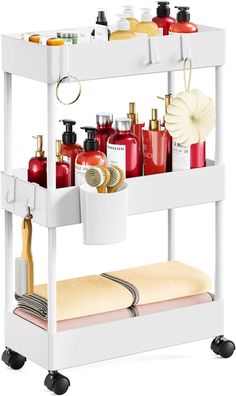 a white shelf with lots of beauty products on it's sides and towels hanging from the top