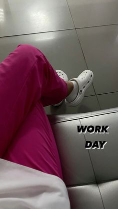 a woman sitting on top of a white couch next to a wall with the words work day written on it