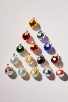 eight ball ornament set on white surface with number one in the middle and six different colors