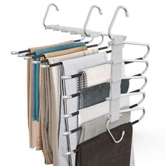 an over - the - door drying rack holds several folded towels and other clothing items