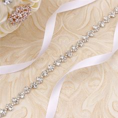 the bridal sash is adorned with crystal stones