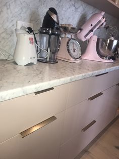 the kitchen counter has many appliances on it, including an electric mixer and blender