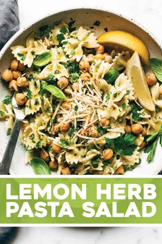 lemon herb pasta salad with chickpeas and spinach in a white bowl on a marble surface