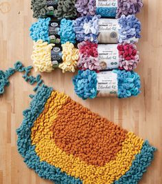 crocheted dishcloths and scrubcloths laid out on a wooden floor