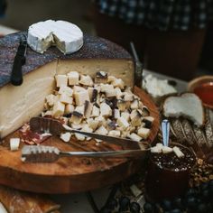 a cheese platter with several different types of cheese on it