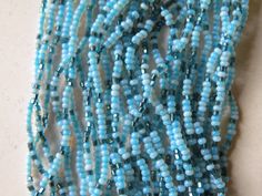 "Blue seed beads, extra small beads necklace Approximately - 15.5 \" shortest strand and longest strand 18.5\" with clasp. Very good vintage condition." Light Blue Beaded Necklaces With Round Beads, Light Blue Beaded Necklace With Faceted Round Beads, Light Blue Faceted Round Beads Necklace, Light Blue Faceted Round Beaded Necklaces, Blue Beaded Waist Beads, Light Blue Polished Round Beaded Necklaces, Light Blue Polished Beads Necklace, Small Beads Necklace, Christmas Tree Necklace