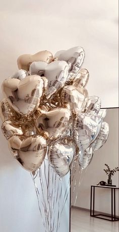 a bunch of balloons that are in the shape of heart - shaped flowers on a table