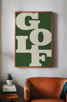 a brown chair sitting next to a green and white painting on the wall in a living room