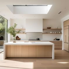 a kitchen with an island and skylight above the countertop, along with wooden cabinets