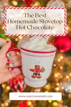 a Christmas mug being held up in front of a Christmas tree filled with homemade stovetop hot chocolate. Hot Chocolate For A Crowd Stovetop, Stovetop Hot Cocoa, Stove Top Hot Cocoa, Stove Hot Chocolate, Stove Top Hot Chocolate Easy, Hot Chocolate Recipes Stovetop, Hotchocolate Homemade Recipe, The Best Hot Chocolate Recipe, Best Hot Chocolate Recipe Homemade