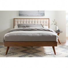 a bed sitting on top of a wooden frame