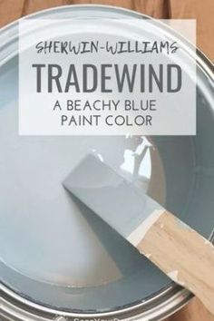 there is a paint can with a brush in it and the words tradewind above it