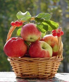 a basket filled with apples sitting on top of a table