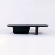 a black coffee table sitting on top of a white floor