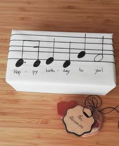 a cake that is decorated to look like music notes and has a tag on it