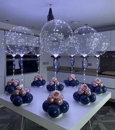 some balloons are sitting on a table in the middle of a room