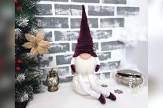 a gnome figurine sitting next to a christmas tree