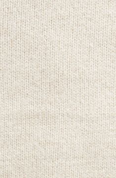 a close up view of the texture of a white knitted fabric material, as seen from above