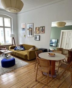 a living room filled with furniture and wooden floors