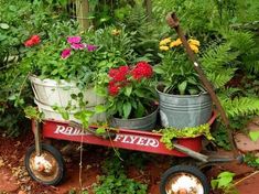 a red wagon filled with lots of flowers