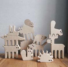 a group of wooden animals standing on top of a wooden floor