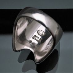 This is a very nice Mid Century Modernist ring by Georg Jensen, Denmark. The ring is style #140 and was designed by Henning Koppel and produced in the 1970's. The ring is marked inside the band with the Jensen mark, Danish Sterling purity stamp, and style number. The ring is in very good vintage condition with only light age related wear. Please be sure to view all of the photos for a complete view of the ring's condition. The ring is a US size 5.5 and weighs .66 Troy ounces. If you have any que Modernist Signet Ring With Polished Finish For Anniversary, Modernist Open Ring With Polished Finish, Modernist Polished Finish Ring For Anniversary, Modernist Signet Ring With Polished Finish, Modernist Ring With Polished Finish For Anniversary, Modernist Rings With Polished Finish For Anniversary, Modern Engraved Hallmarked Open Ring, Modern Engraved Open Ring With Hallmark, Modern White Gold Collectible Rings