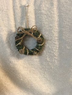 a small wreath hanging on a towel