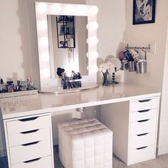 a white vanity with stool and mirror in a room