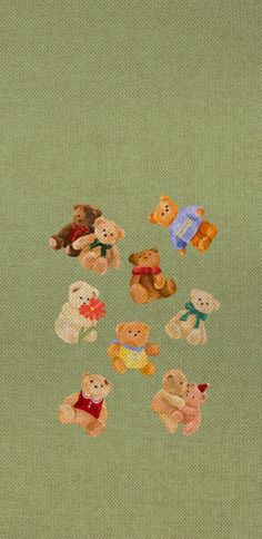 a group of teddy bears sitting on top of a green surface