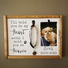 a wooden frame with a dog's name and photo hanging on it