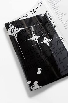 an open book with black and white designs on it