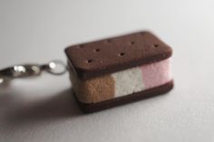 an ice cream sandwich keychain is shown on a white surface