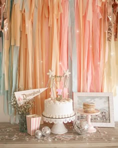 a table topped with a cake and cupcakes