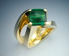 This is a heavy 18k gold woman's ring set with a beautiful, 4.4 ct. fancy cut Green Tourmaline. The ring features sculptural design that twists from a wide shank to dramatically present the rich, checkerboard cut Tourmaline. The total weight of the ring is 22.5 grams and it is a size 6.25. This ring can be sized 1/2 size up or down, and this is done free of charge. The price of this piece is $5550. Wax Carving Jewelry, Jewelry Rings Unique, Jewelry Wax, Mens Gold Wedding Band, Green Tourmaline Ring, Fine Jewelery, Womens Ring, Coral Ring, Tourmaline Ring