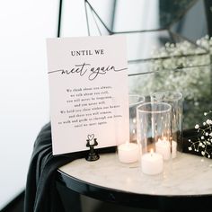 a table with candles and a sign that says until we meet again