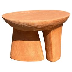 a small wooden table sitting on top of a white surface