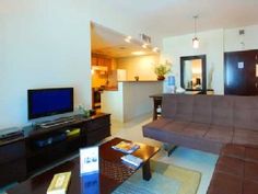 a living room filled with furniture and a flat screen tv