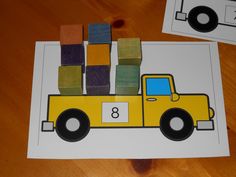 a yellow truck with blocks on the back and number 8 cut out from it's side