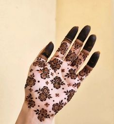 a woman's hand with henna on it