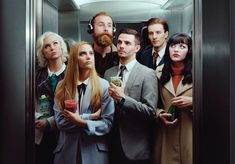 a group of people standing in an elevator