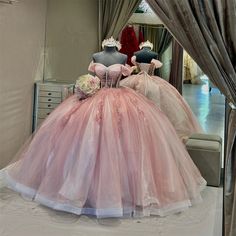 two mannequins dressed in pink and white gowns