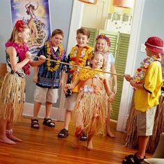 some kids are dressed up and standing in the living room